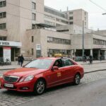 Ένα κόκκινο ταξί σταθμευμένο έξω από κτίριο νοσοκομείου στη Βιέννη