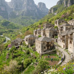 Eine kleine, orthodoxe Steinkirche in einem griechischen Bergdorf an einem sonnigen Frühlingstag.