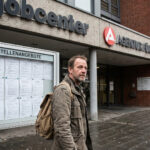 Πολίτες διαβάζουν ανακοινώσεις για θέσεις εργασίας σε πίνακα ανακοινώσεων στη Γερμανία