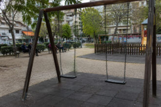 Ein leerer Spielplatz in einer griechischen Stadt im Nachmittagslicht.