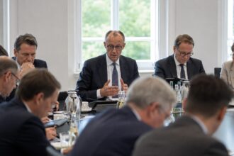 Ο Γερμανός καγκελάριος Friedrich Merz με σκεφτική έκφραση κατά τη διάρκεια πολιτικής εκδήλωσης.